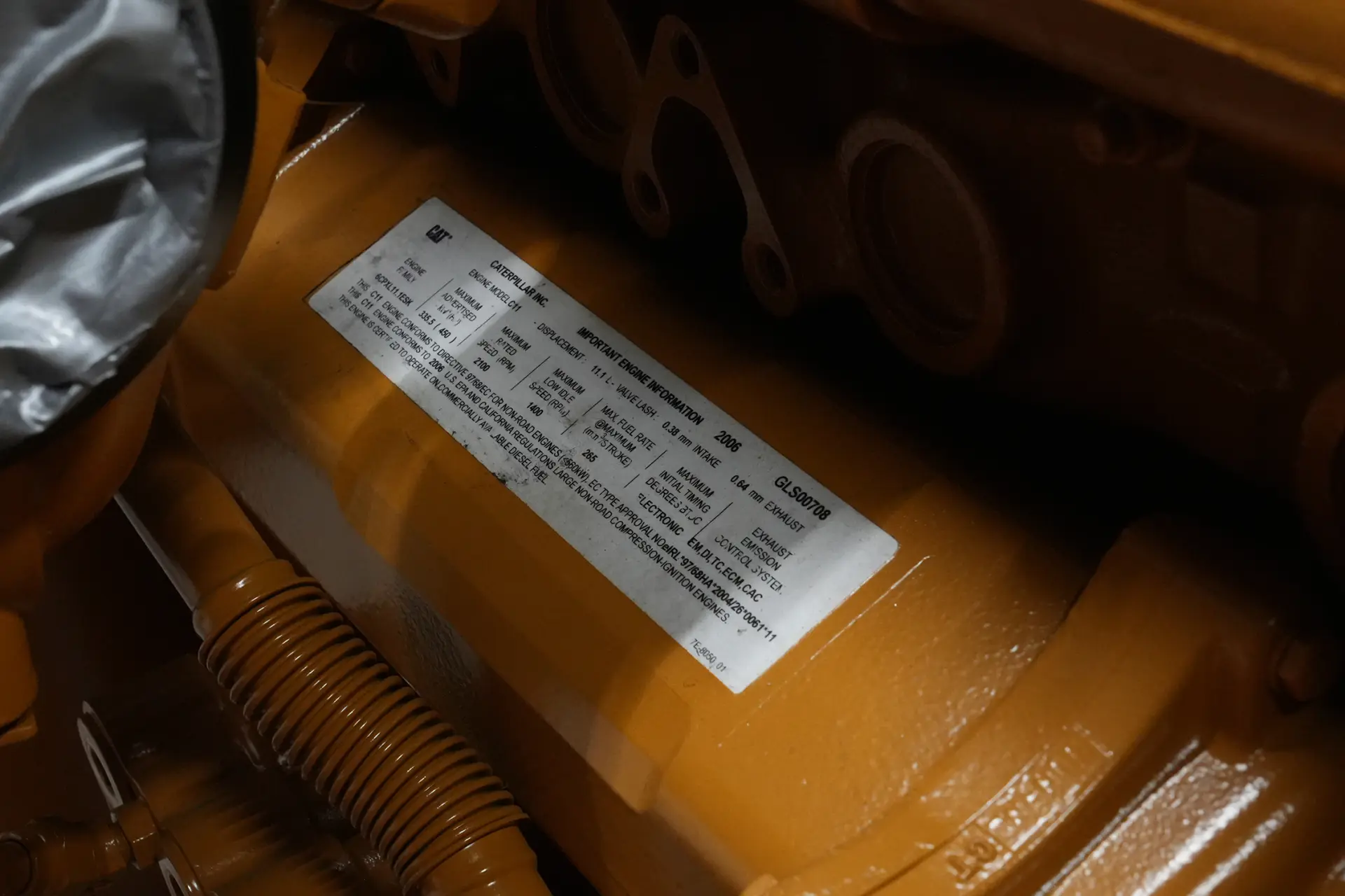 Caterpillar C11 emissions and technical information label on engine block
