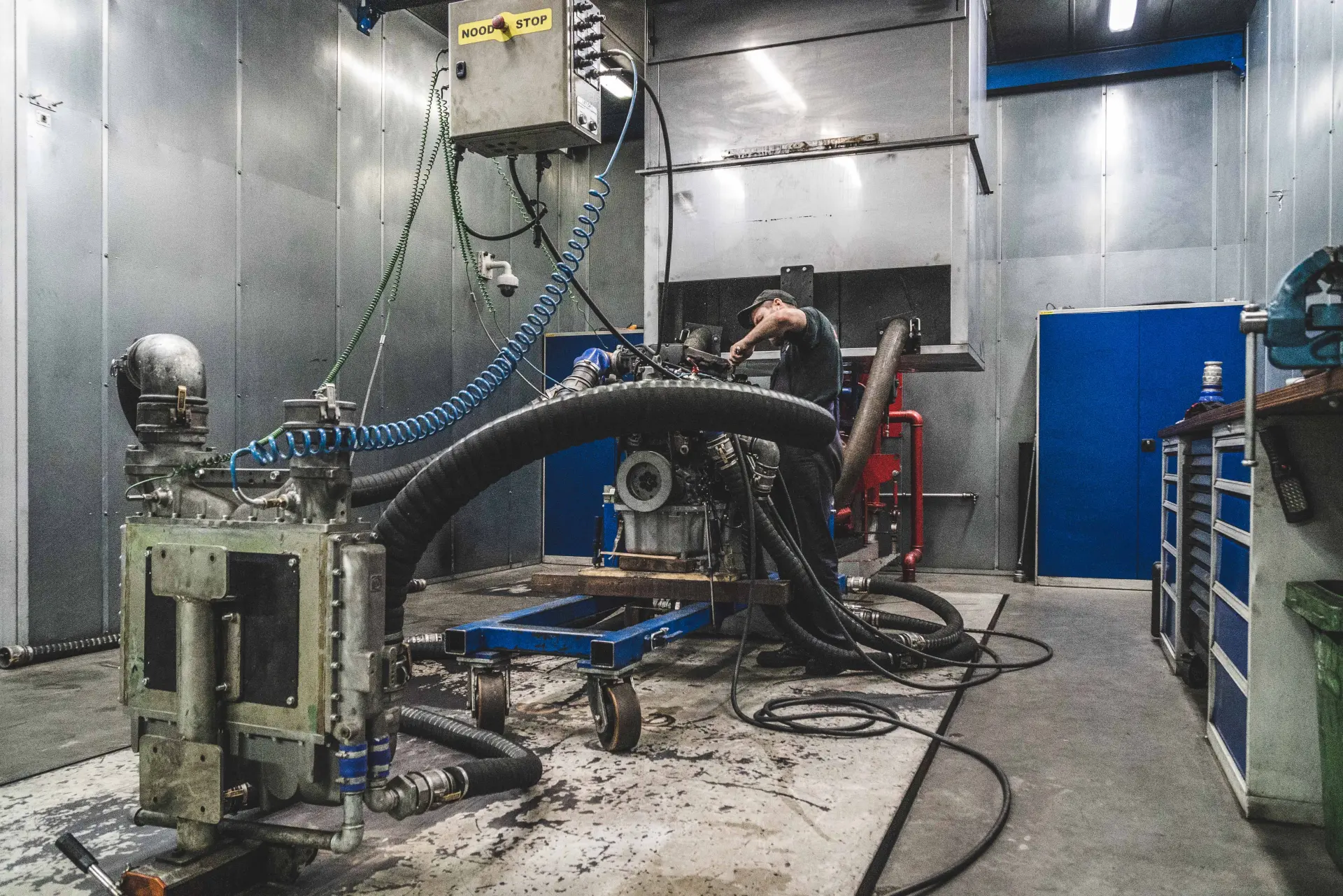 Hamofa technician testing a reconditioned diesel engine on the test bench in the workshop