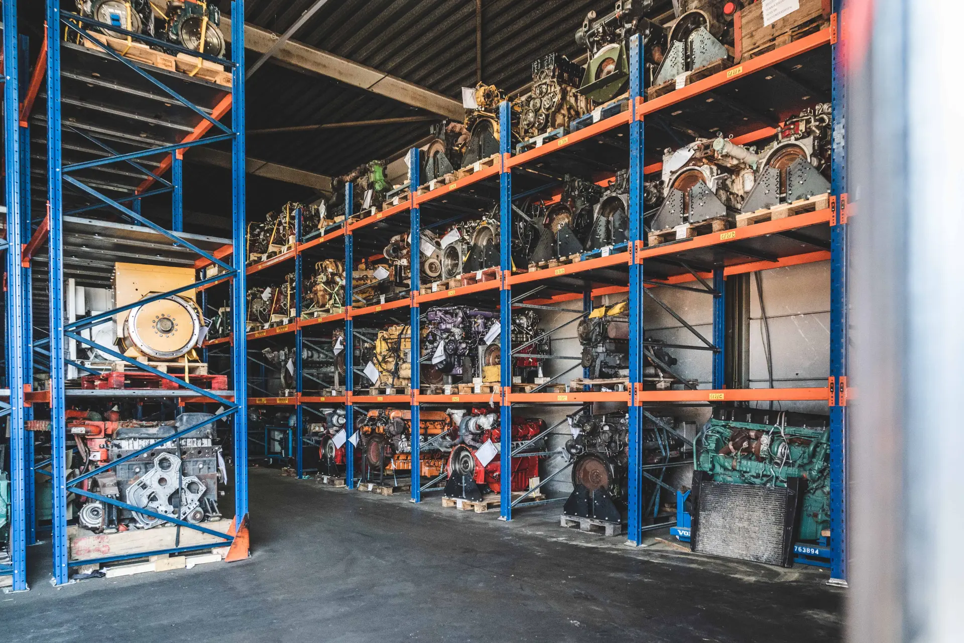 Hamofa warehouse with racks full of reconditioned diesel engines and engine parts, ready for delivery